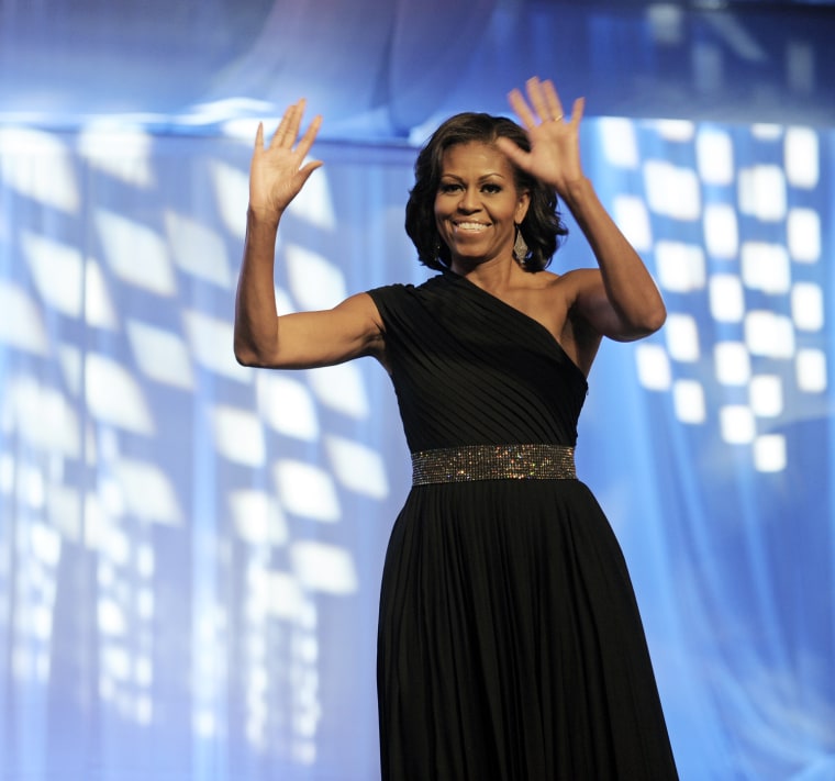 First lady Michelle Obama waves as she is introduced onstage to address the Congressional Black Caucus Foundation's 42nd Annual Phoenix Awards dinner in Washington, Saturday, Sept. 22, 2012. (AP Photo/Cliff Owen)
